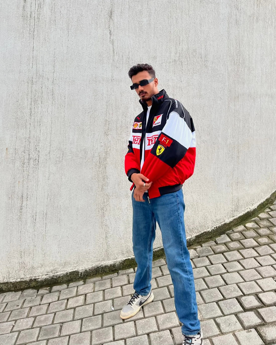 Person wearing a red and black jacket with ferrari logo printed on it