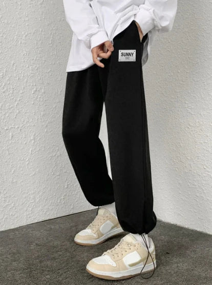 Model wearing Formova Black Classic Track Pant with premium streetwear fit and comfortable athletic design